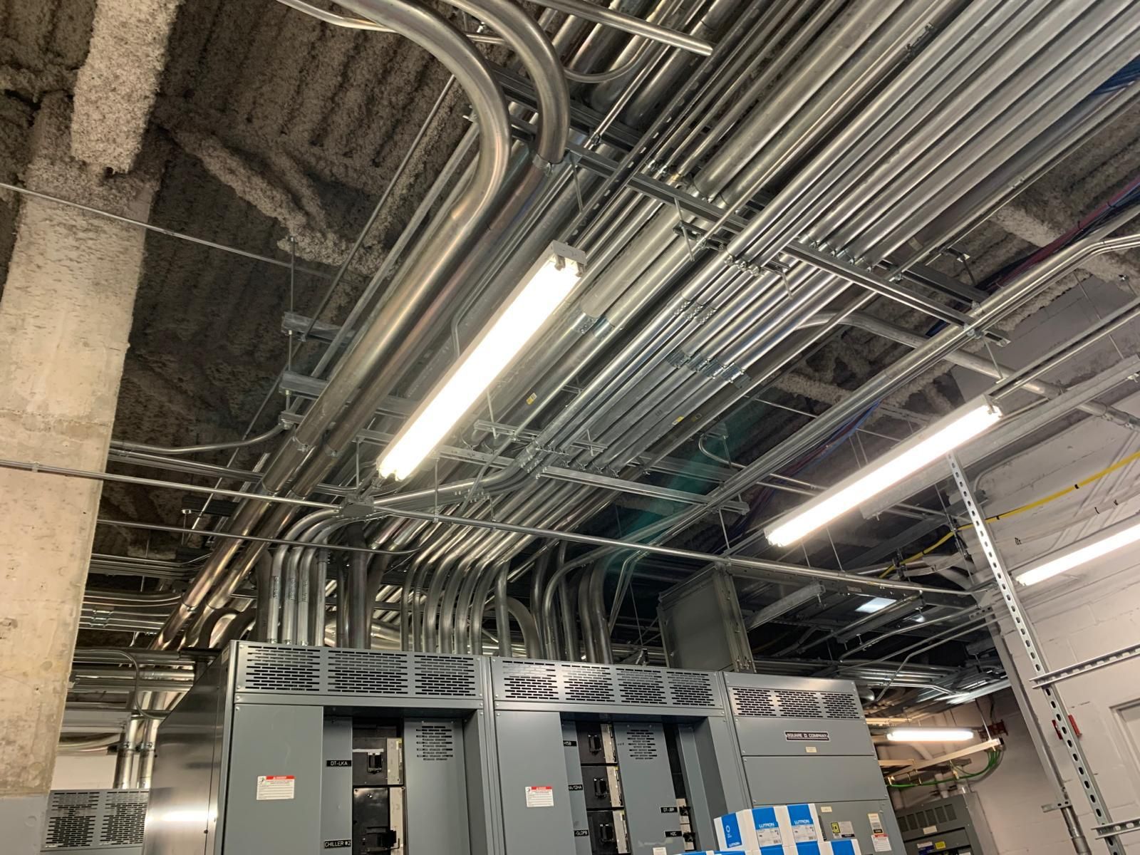 Overhead conduit rack running down a corridor